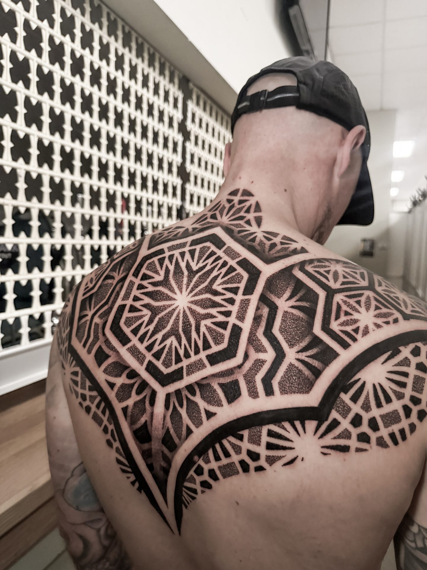 Detailed geometric mandala back piece by Liam Couper