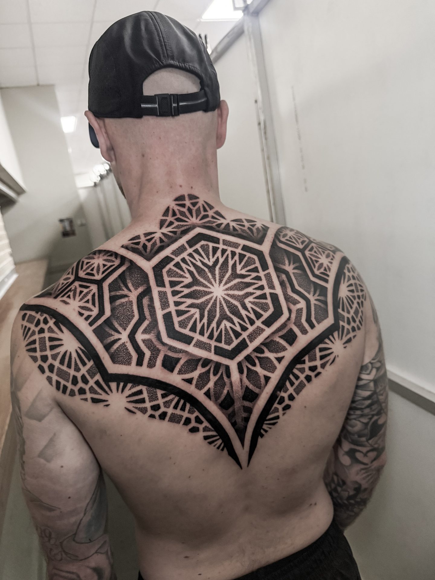 Full geometric mandala back piece tattoo by Liam Couper