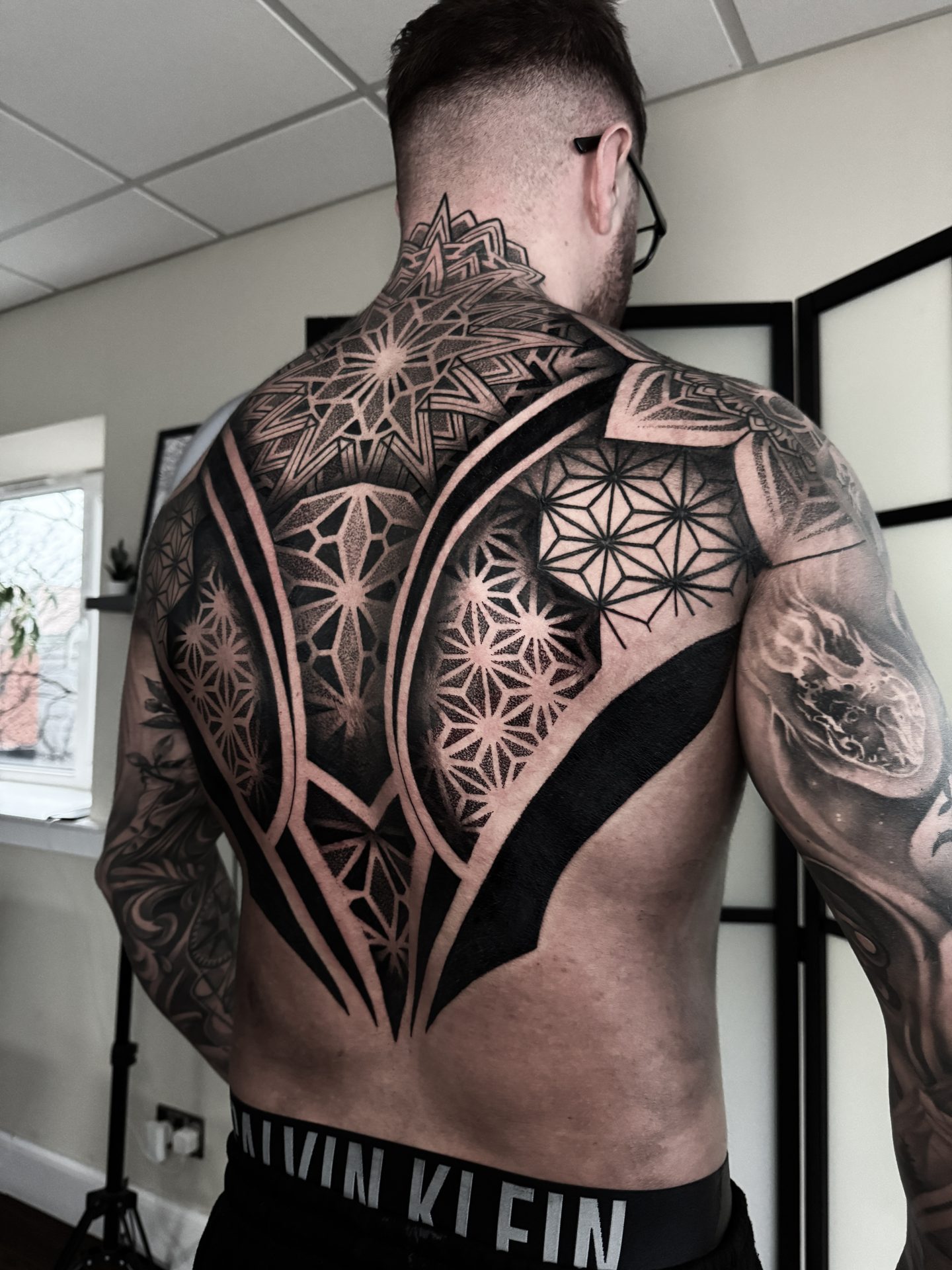 Wide geometric blackwork back piece by Liam Couper, Fife