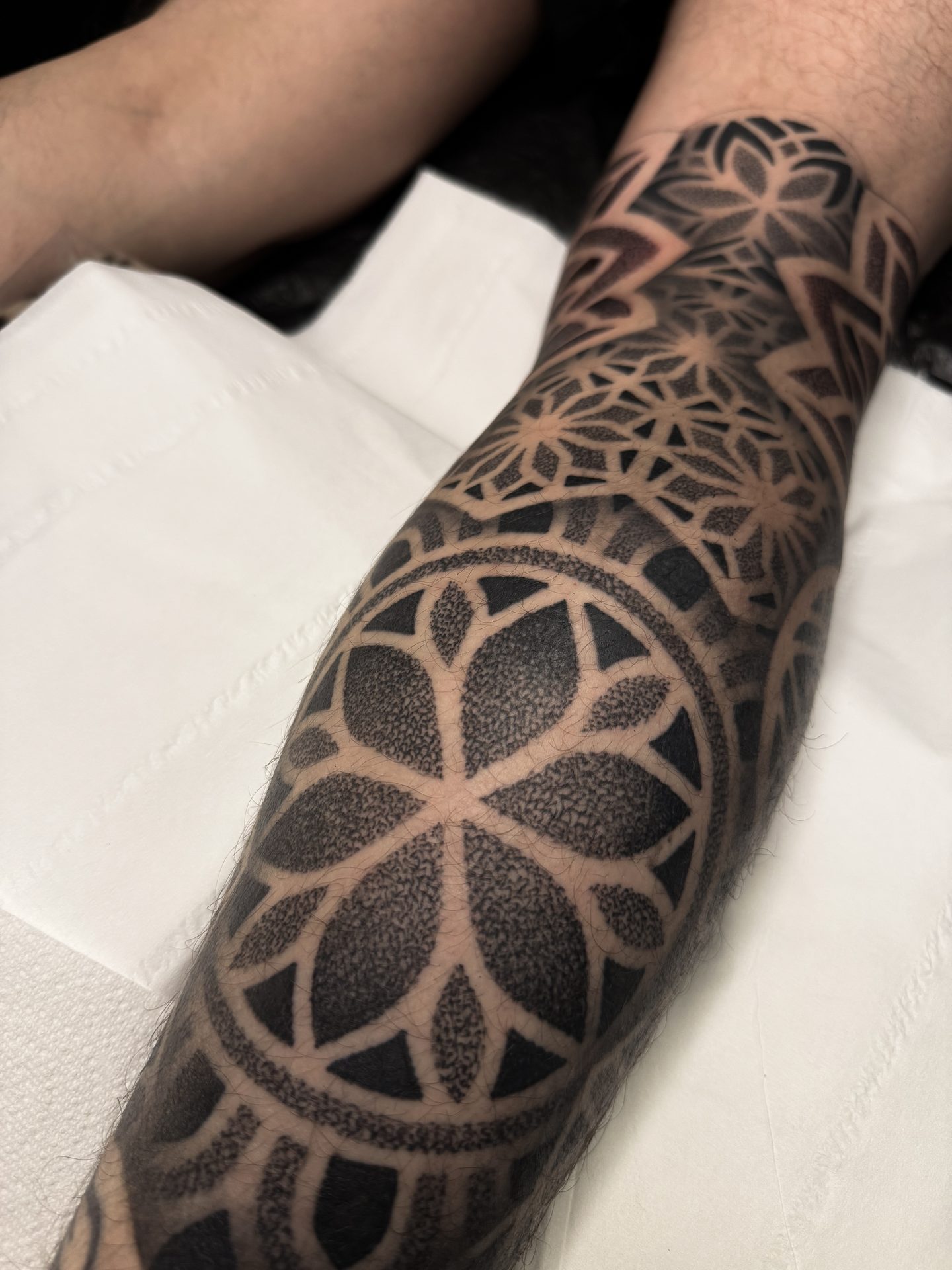 Geometric mandala calf tattoo by Liam Couper, Fife