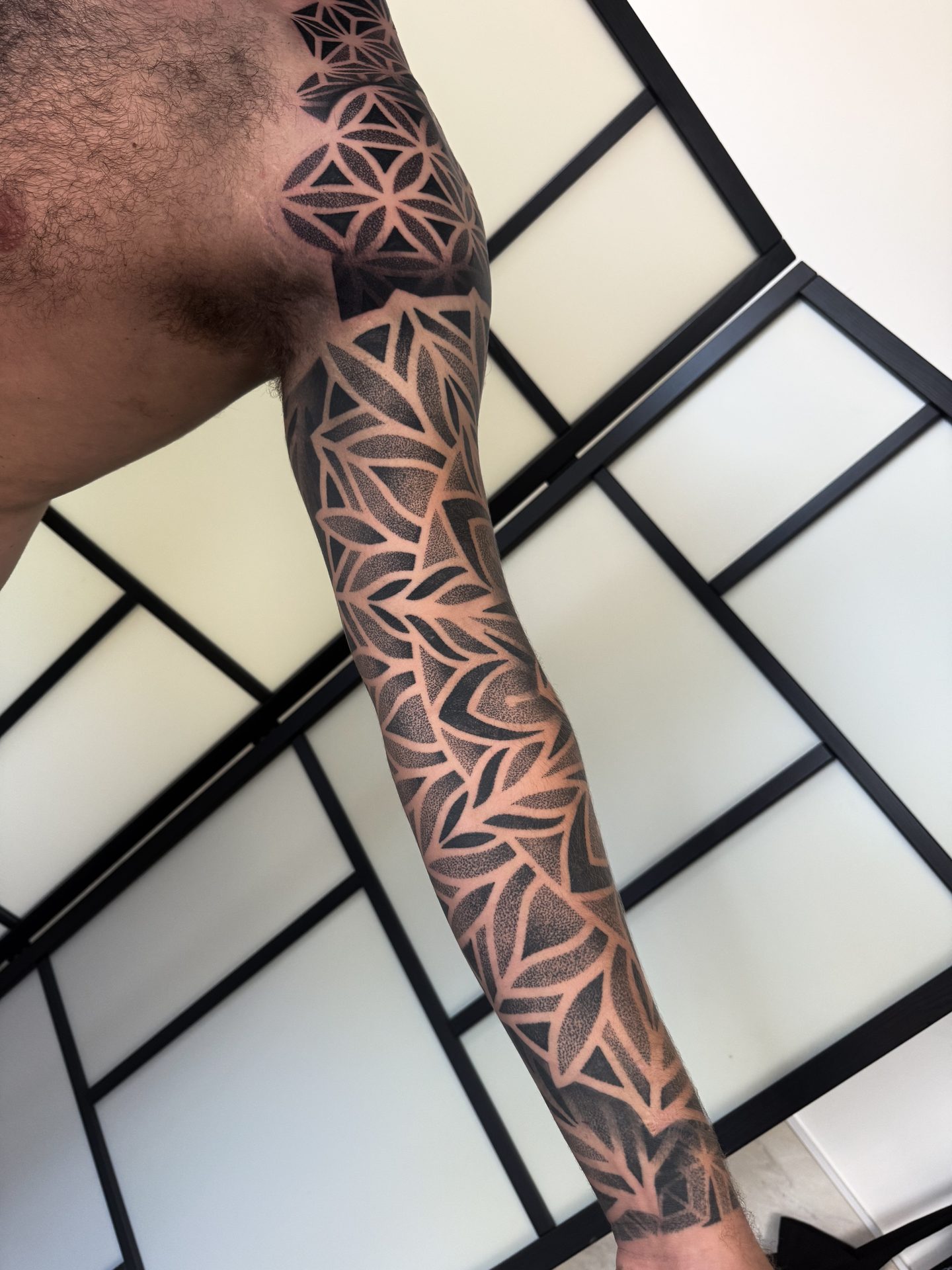 Geometric forearm sleeve tattoo by Liam Couper