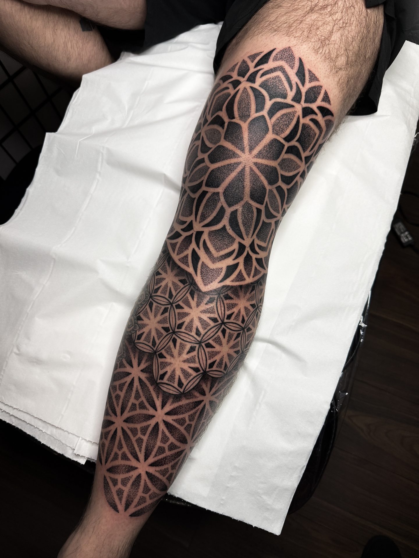 Geometric forearm wrap tattoo by Liam Couper, Fife
