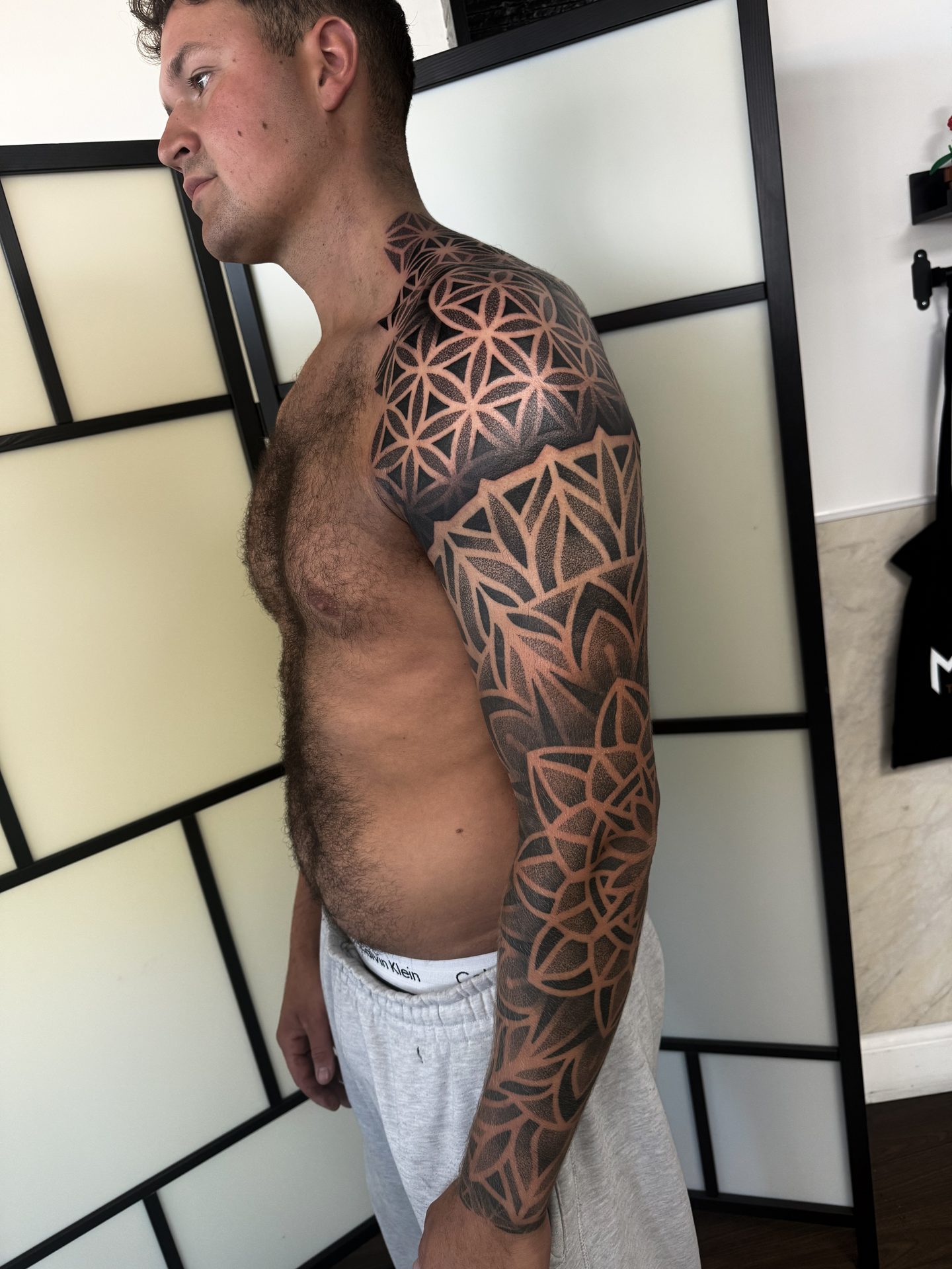Geometric half sleeve and shoulder tattoo by Liam Couper