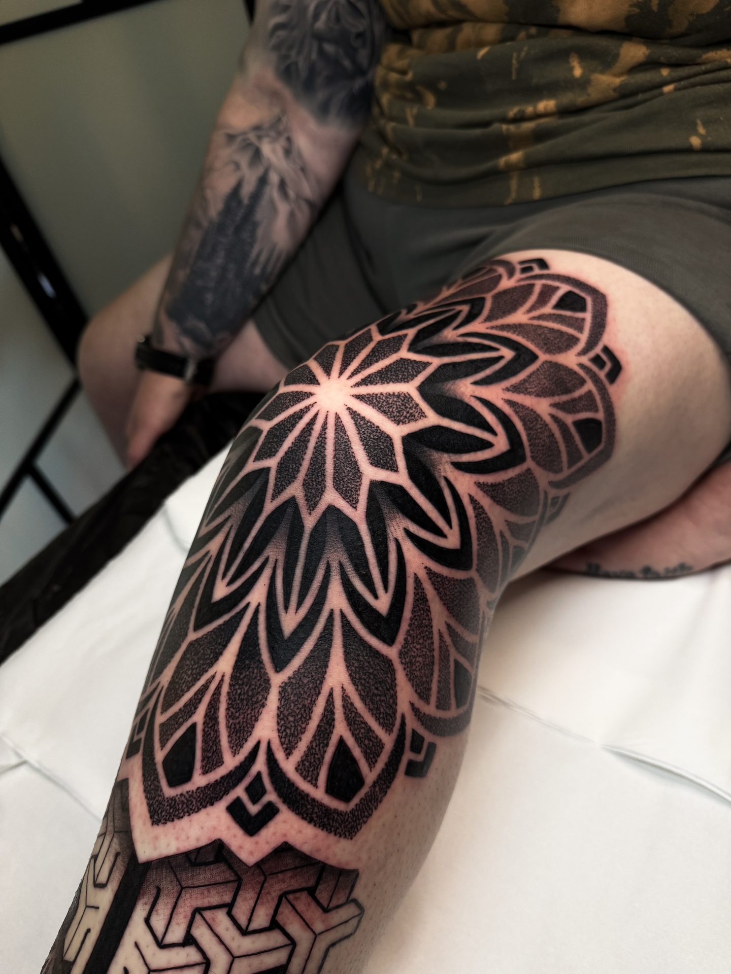 Geometric mandala knee and leg sleeve tattoo by Liam Couper
