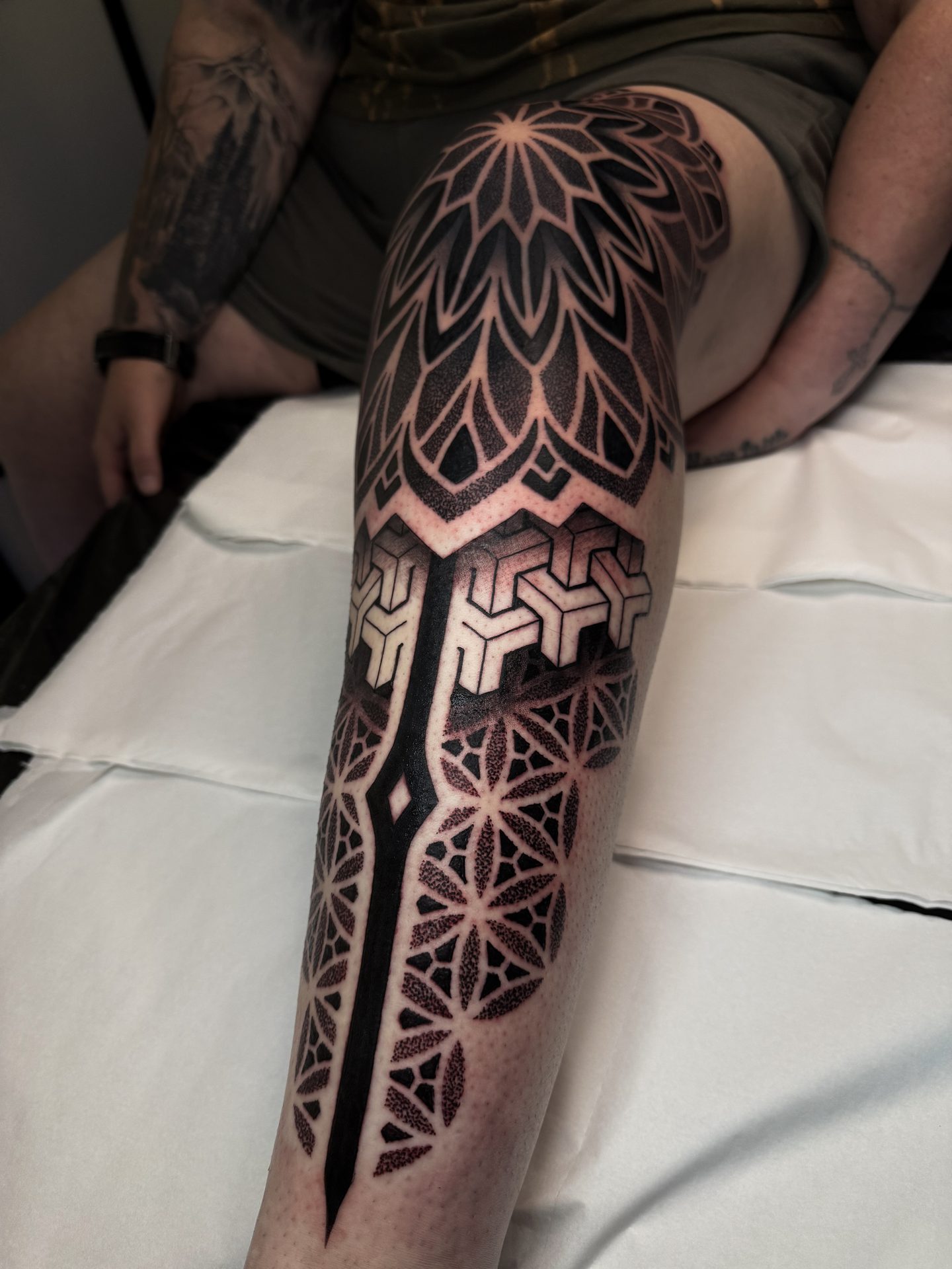 Heavy blackwork geometric leg sleeve by Liam Couper