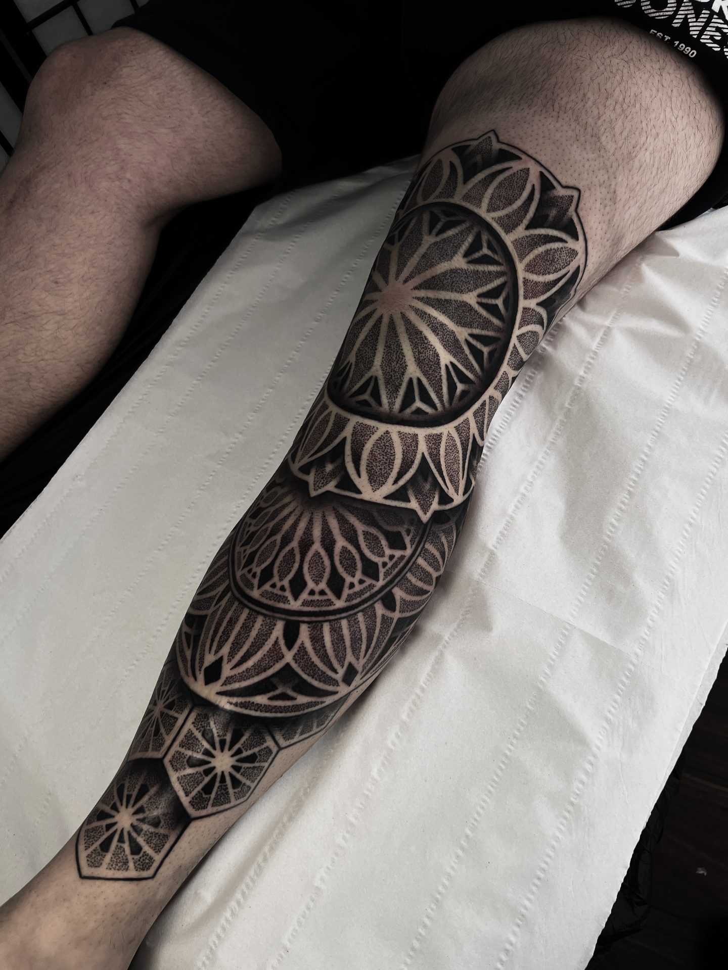 Geometric leg sleeve tattoo by Liam Couper