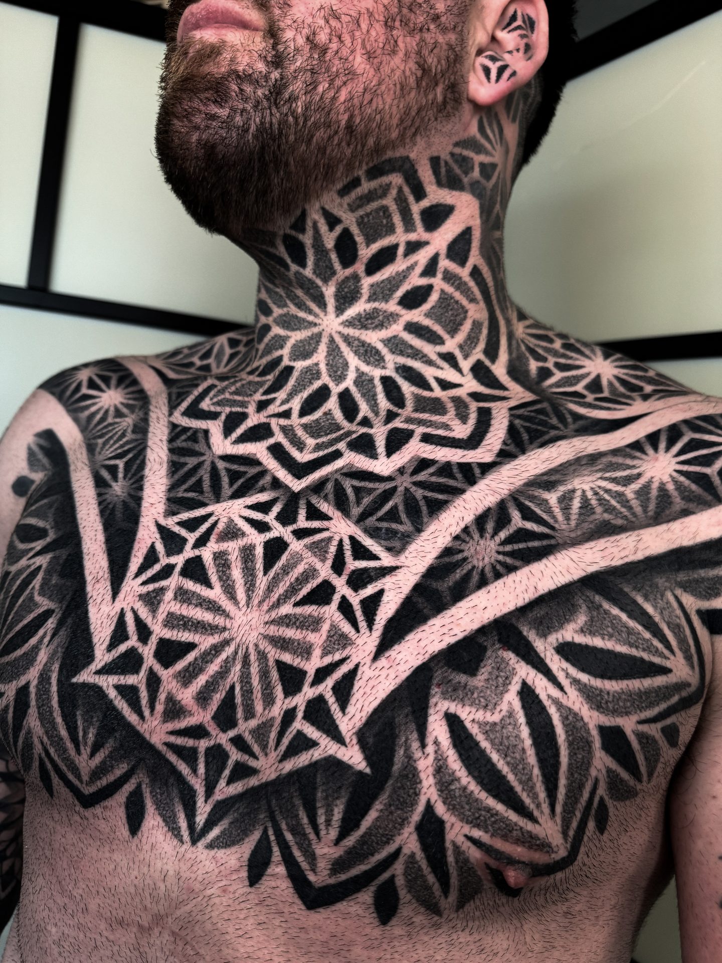 Geometric neck and upper back tattoo by Liam Couper, Fife