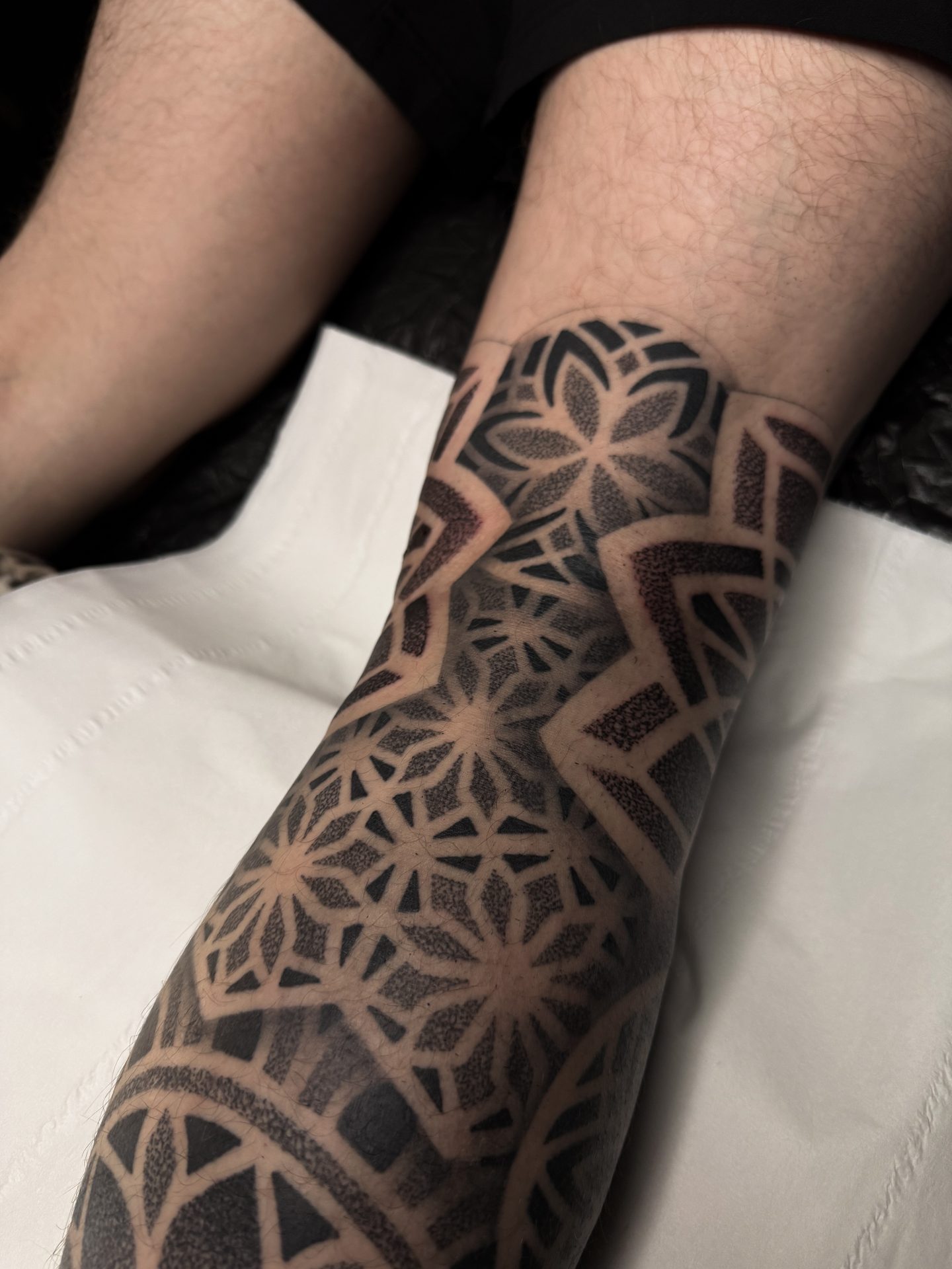 Geometric dotwork shin sleeve tattoo by Liam Couper