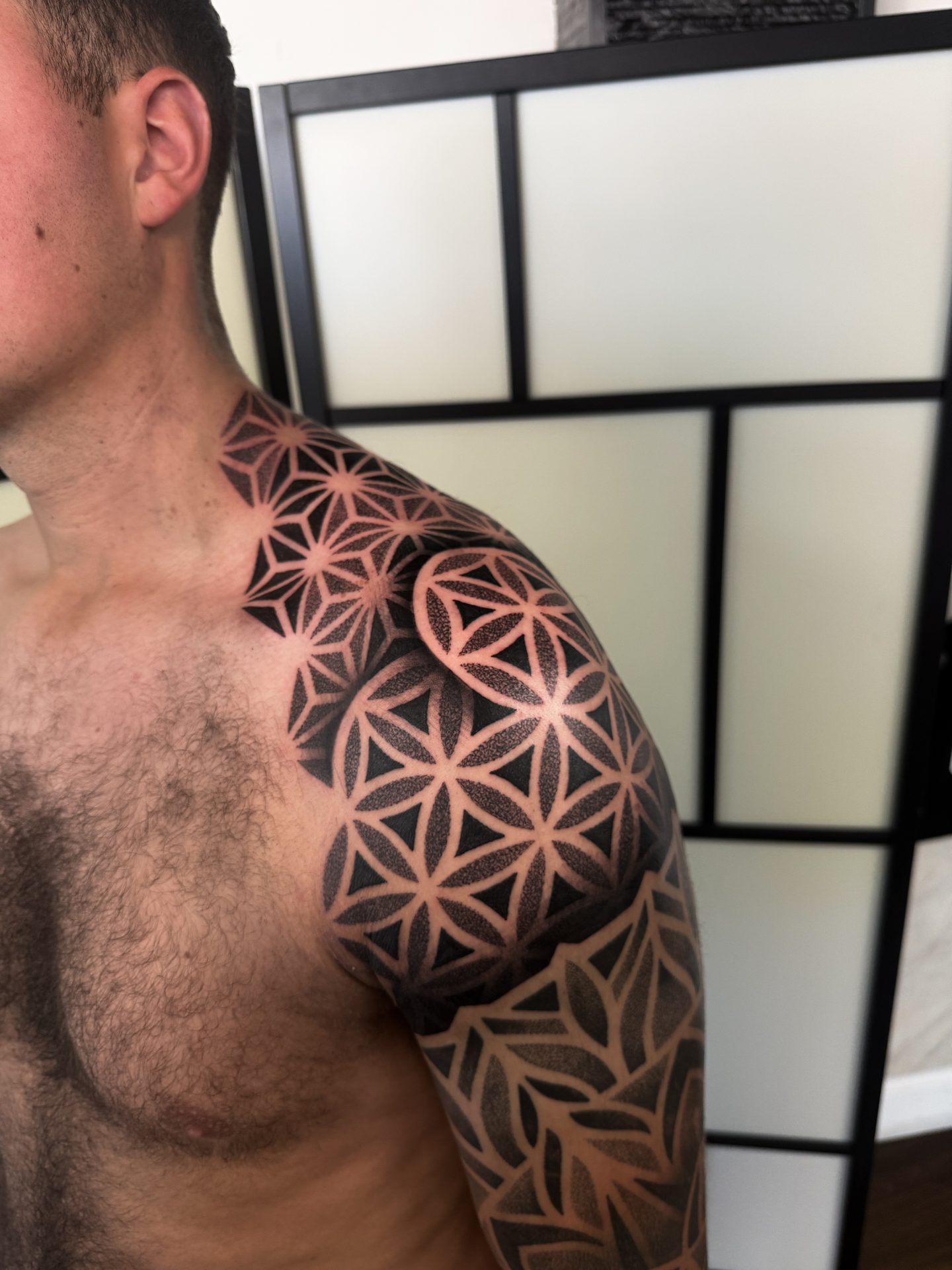 Geometric shoulder blade tattoo by Liam Couper, Fife