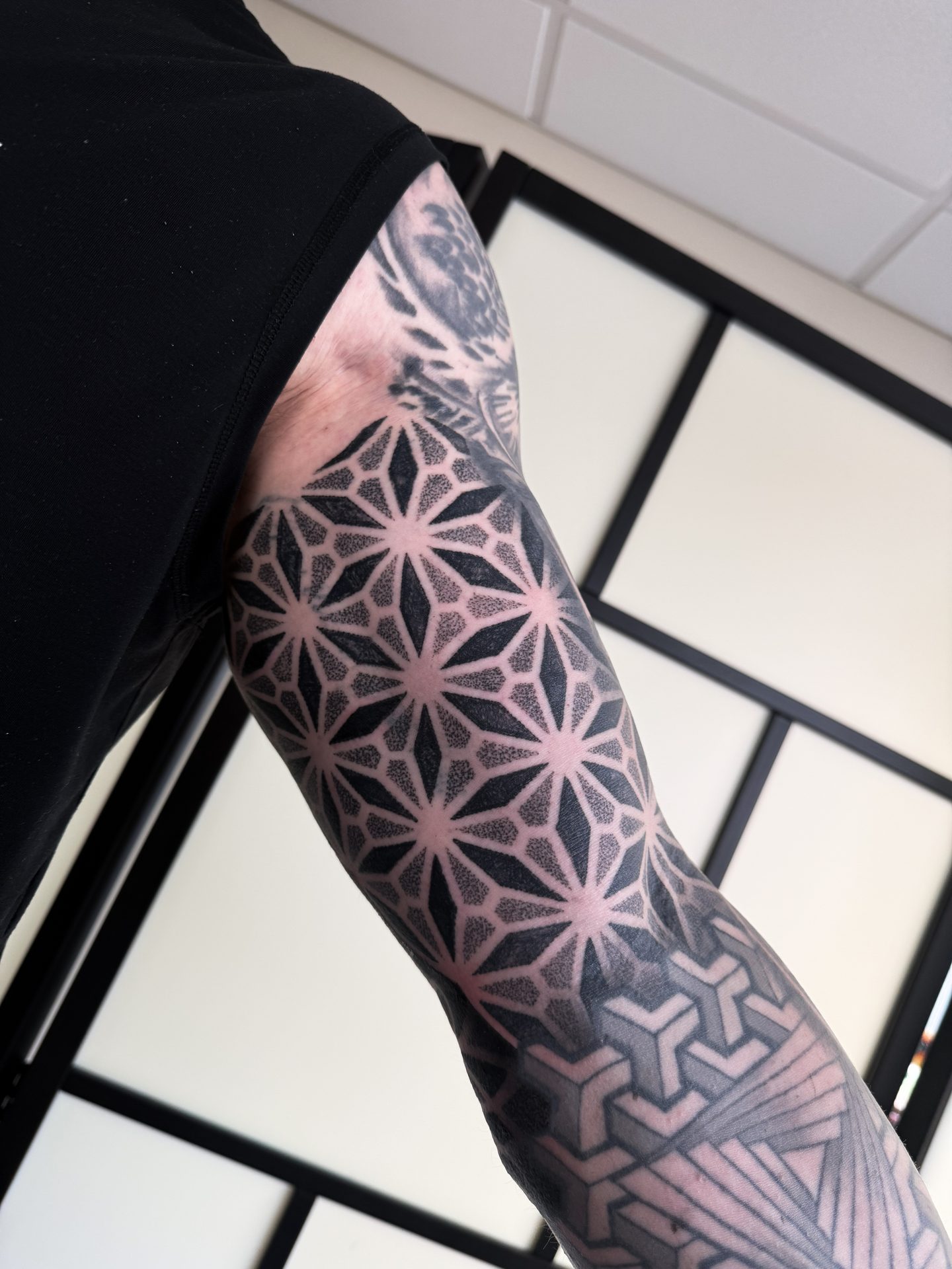 Geometric pattern full sleeve tattoo by Liam Couper, Fife