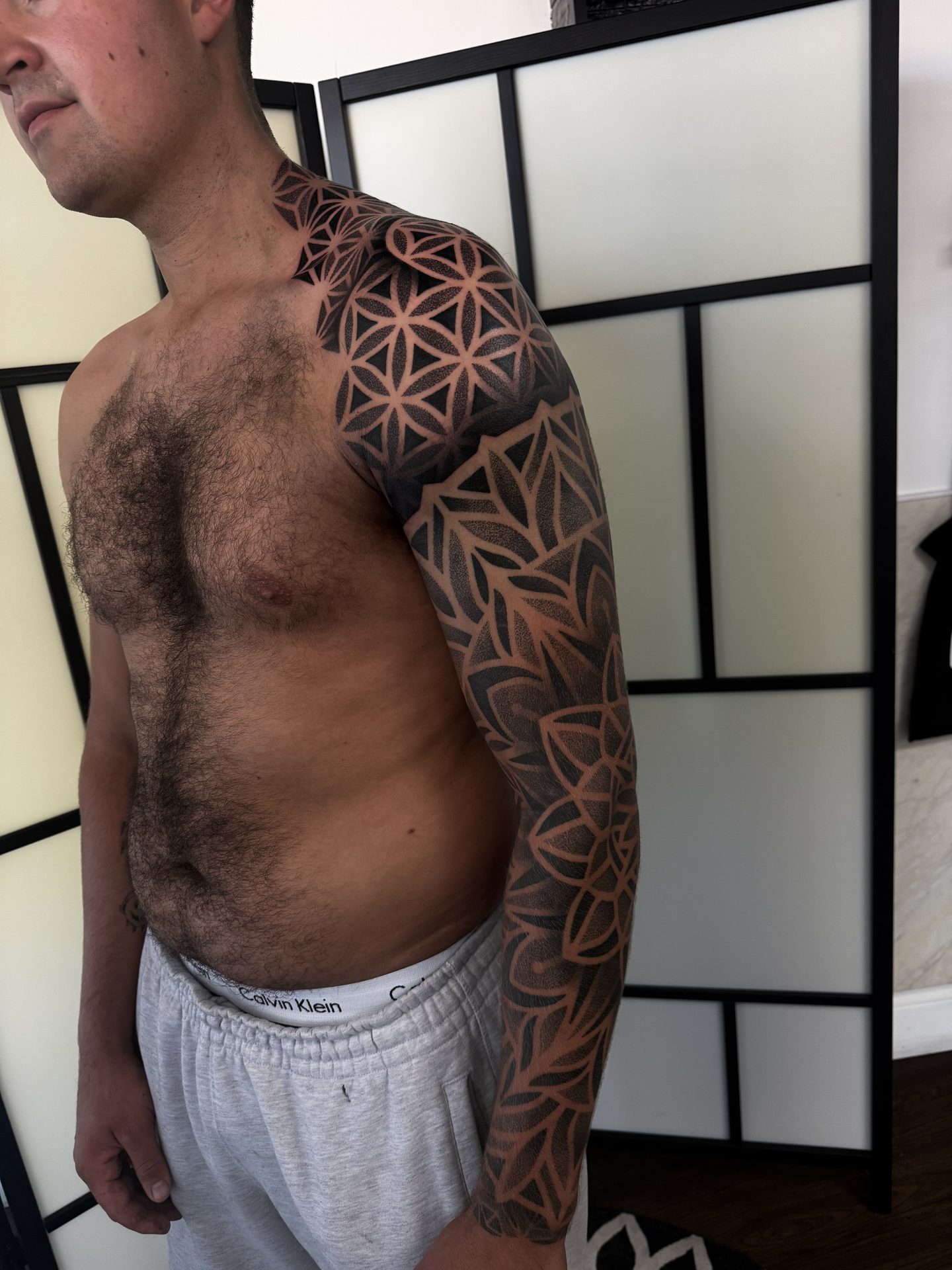 Geometric sleeve and shoulder tattoo, side view, by Liam Couper
