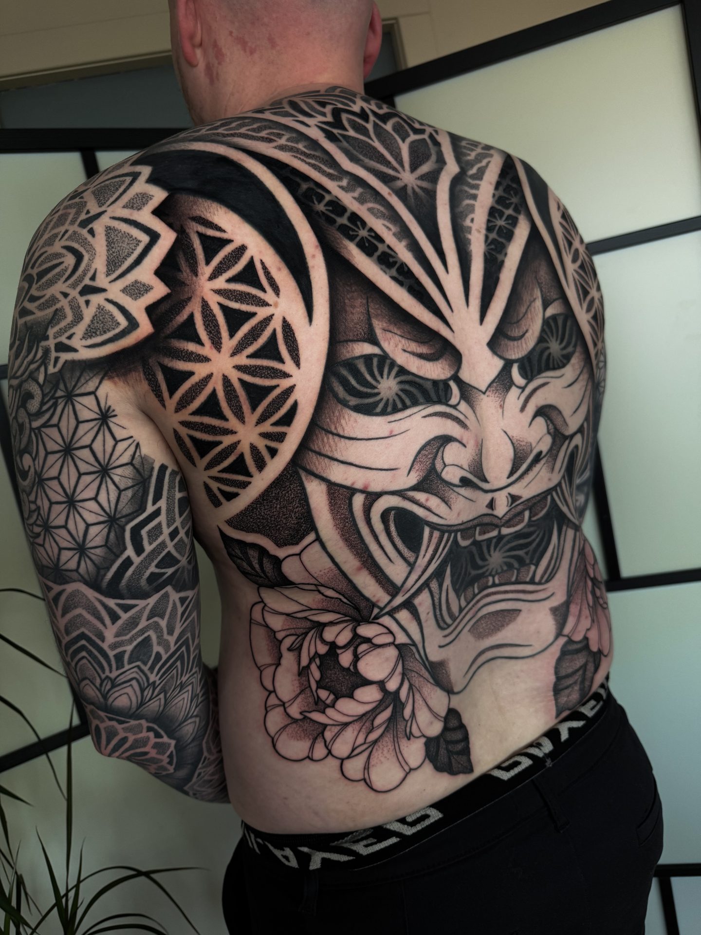 Large geometric torso project with mask centrepiece by Liam Couper
