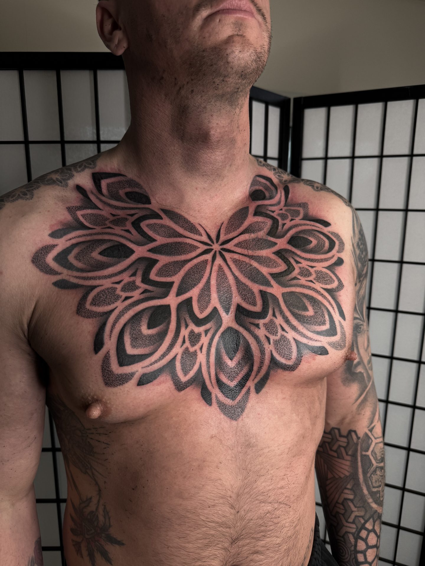 Mandala chest piece tattoo by Liam Couper