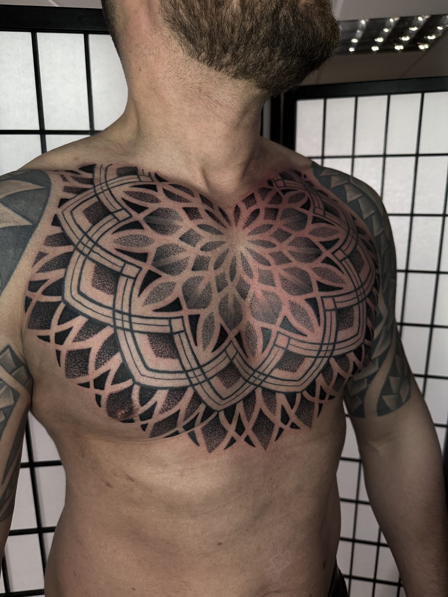 Large mandala chest piece tattoo by Liam Couper