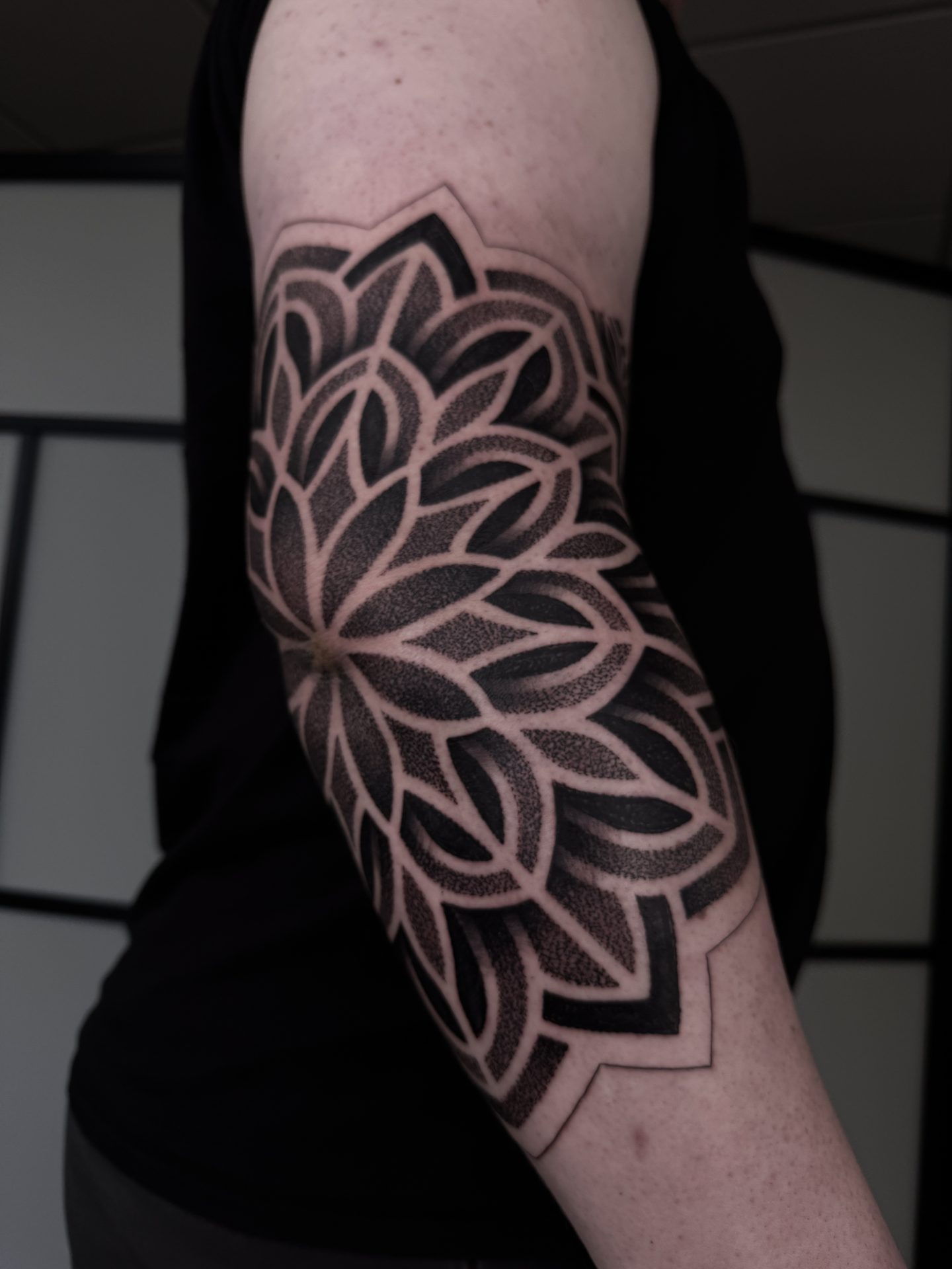 Dotwork mandala elbow tattoo by Liam Couper
