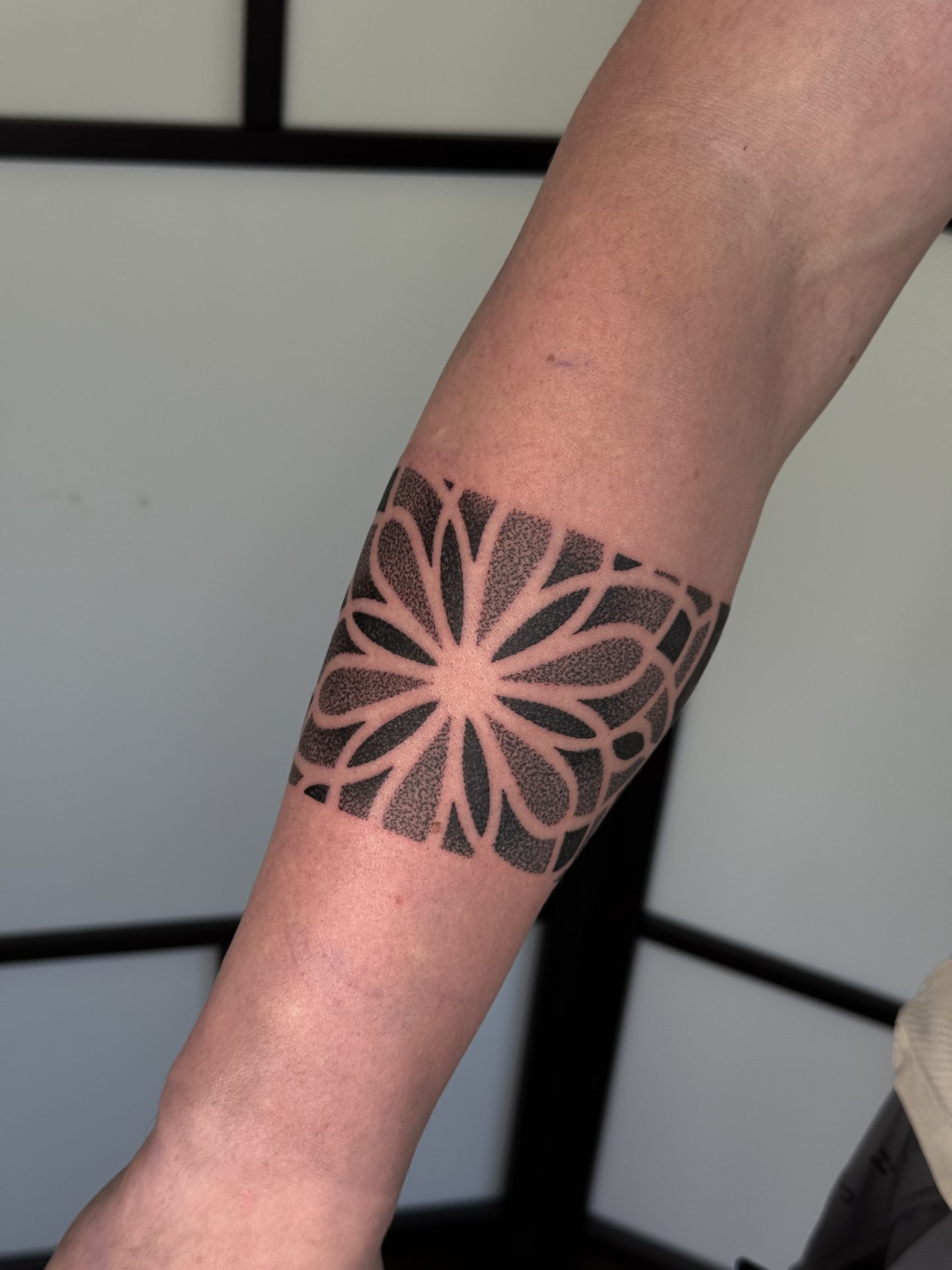Mandala forearm band tattoo by Liam Couper