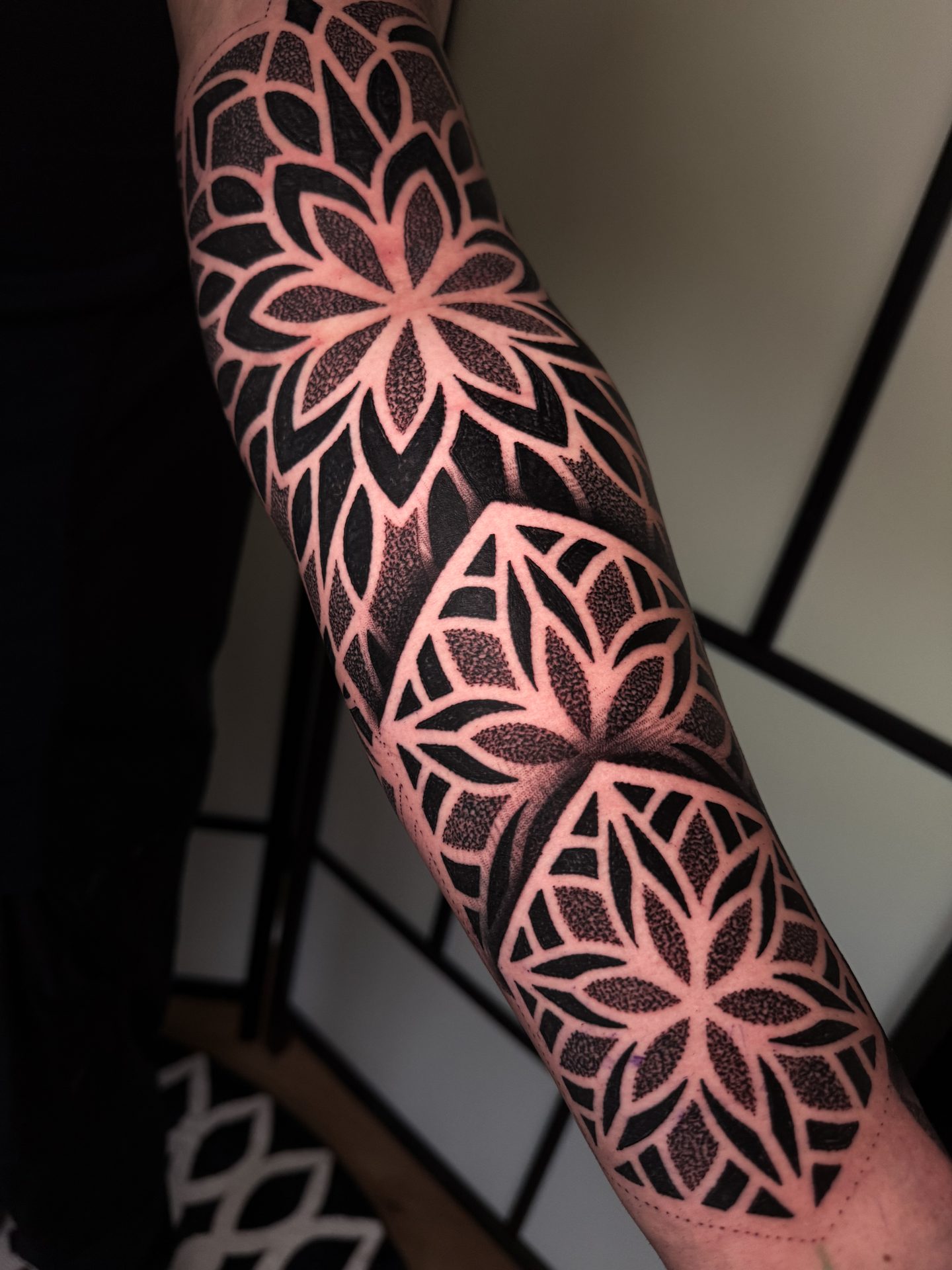 Floral mandala forearm tattoo by Liam Couper