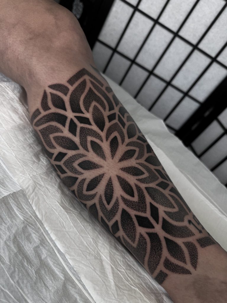 Dotwork mandala forearm tattoo by Liam Couper