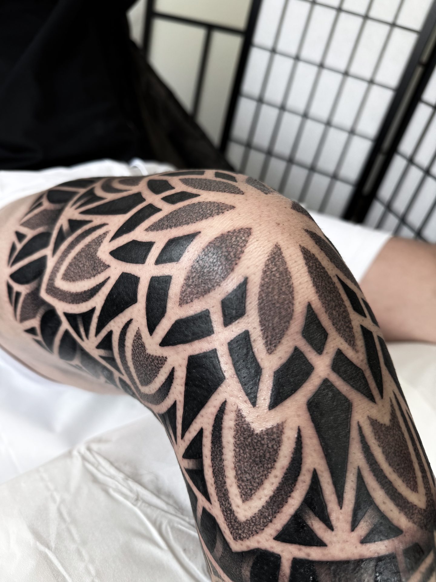 Large mandala knee tattoo by Liam Couper