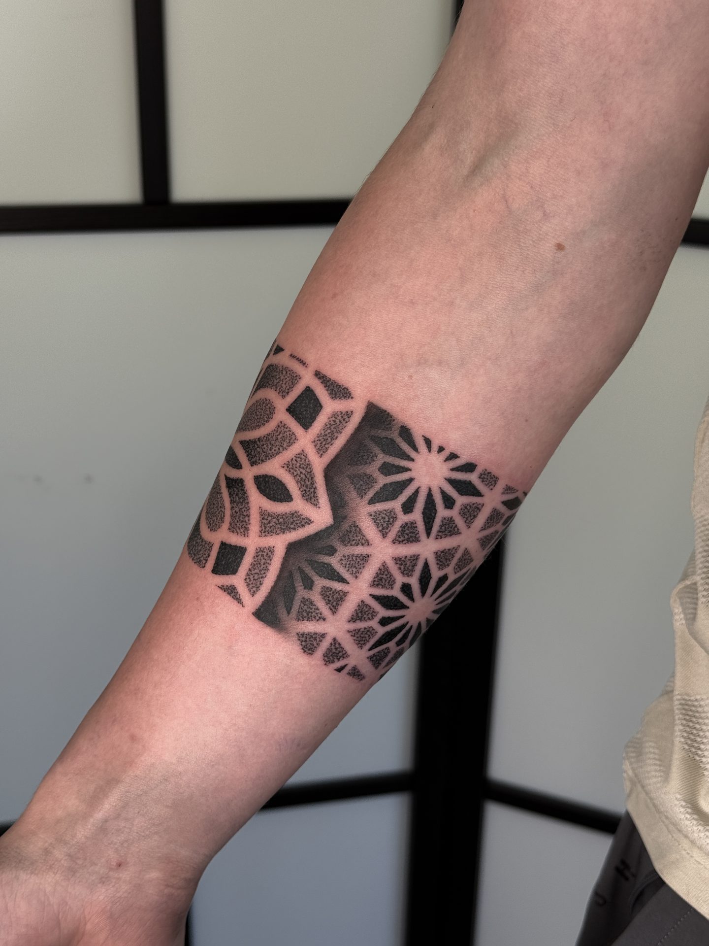 Mandala wrist cuff tattoo by Liam Couper