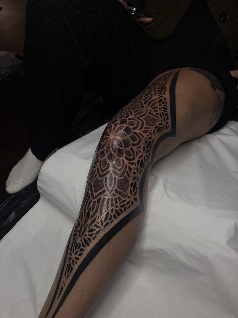 Ornamental leg sleeve tattoo by Liam Couper