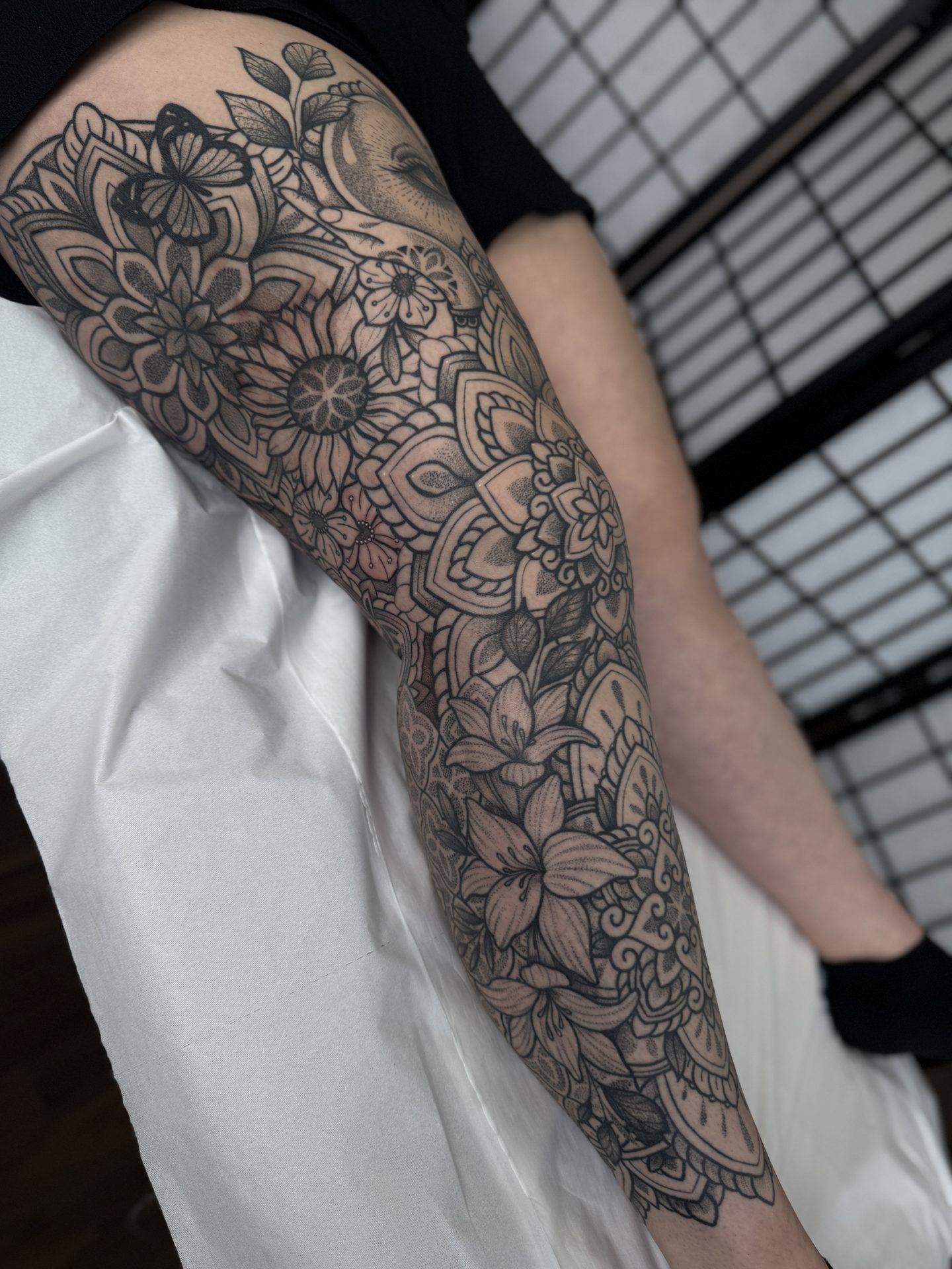 Ornamental thigh and leg sleeve tattoo by Liam Couper, Fife