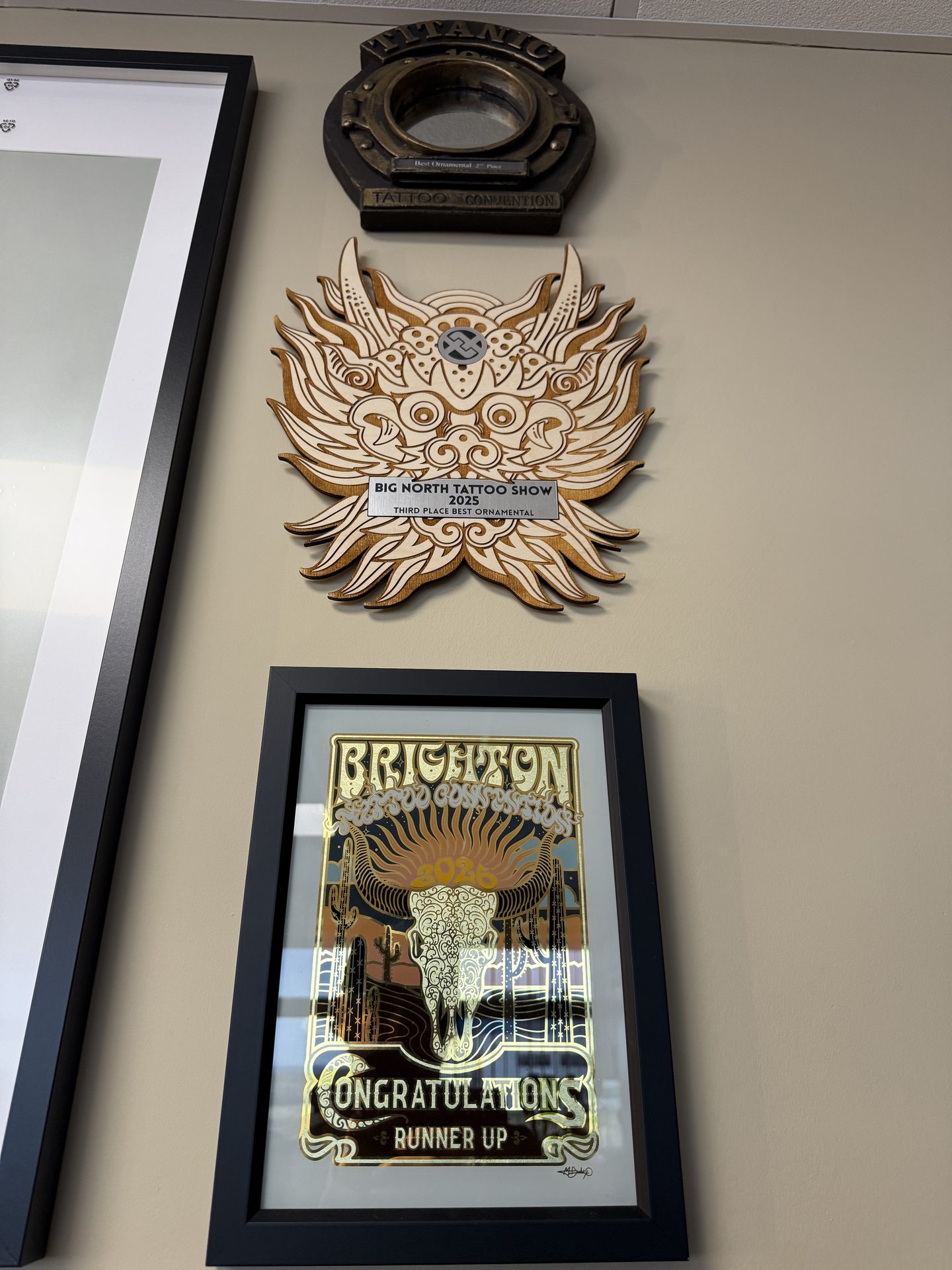 Convention awards on the wall of the coupstattoo studio